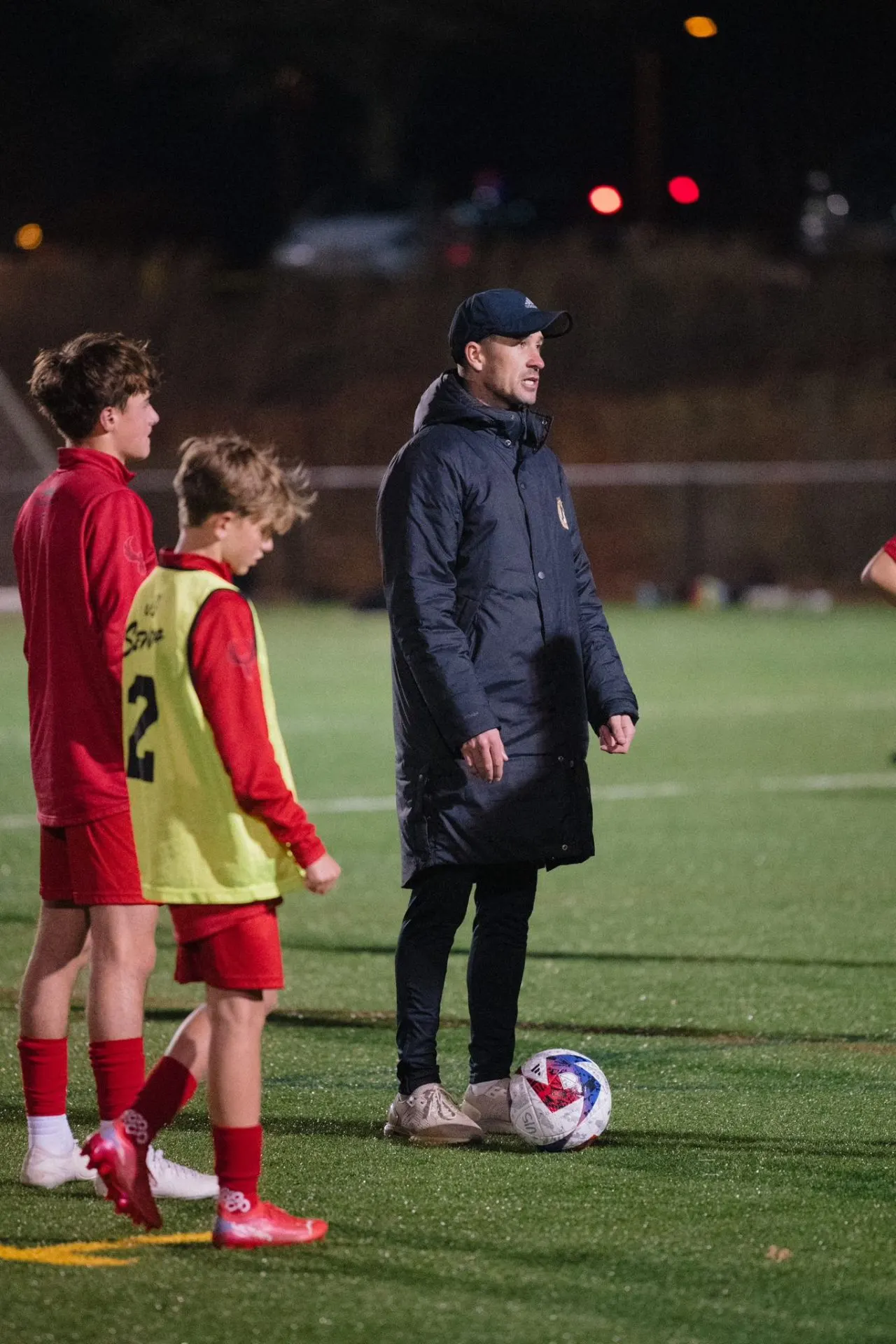 Charlie Foster coaching players at night